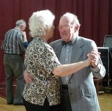 Elderly couple dancing.